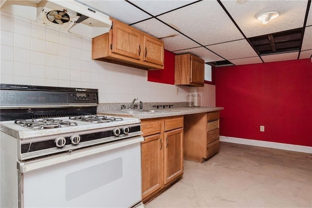 kitchen with tasteful backsplash, brown cabinets, white gas range oven, ventilation hood, and concrete floors