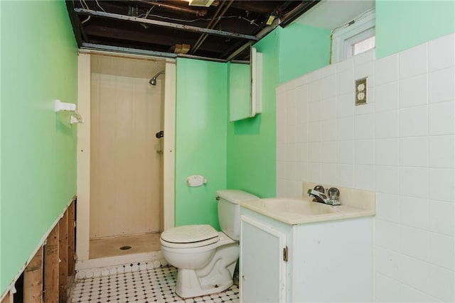 bathroom with a shower stall, vanity, and toilet