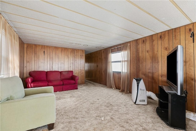 living room featuring wooden walls and carpet