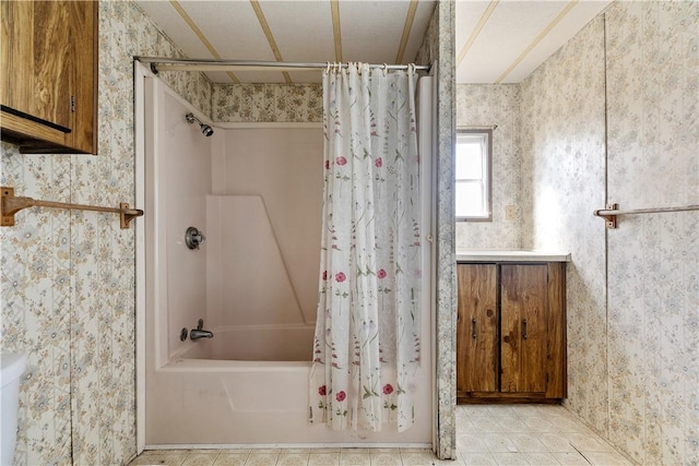 full bathroom featuring wallpapered walls, vanity, and shower / bath combo