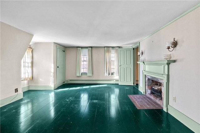 unfurnished living room featuring baseboards, baseboard heating, a high end fireplace, and wood finished floors