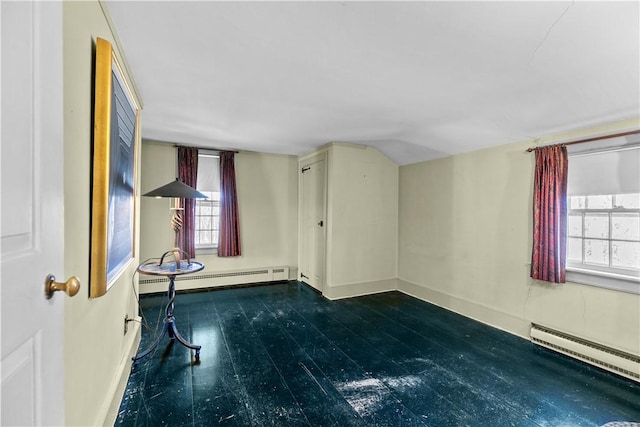 interior space with vaulted ceiling, a baseboard radiator, baseboards, and baseboard heating