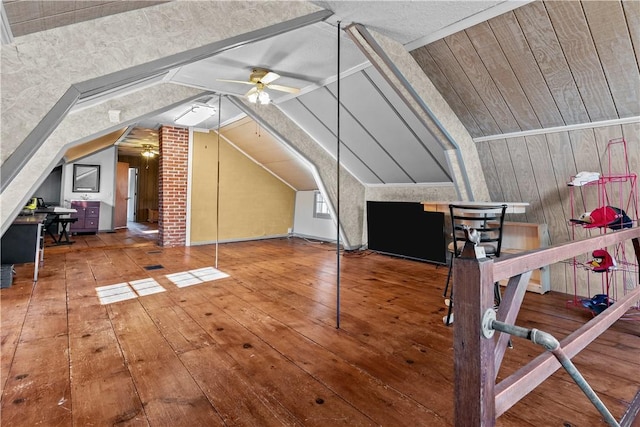 additional living space featuring wood-type flooring, vaulted ceiling, and ceiling fan