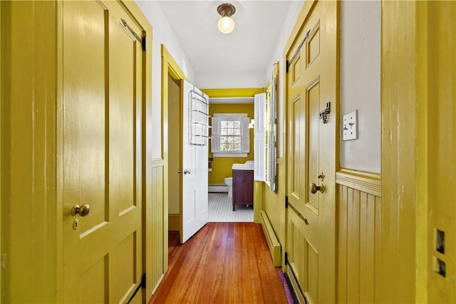 hallway featuring a baseboard radiator and dark wood-style flooring