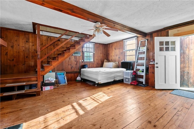 237 Commonwealth Ave, Warwick, RI 02886 - bedroom with hardwood / wood-style flooring, wood walls, beam ceiling, and a textured ceiling