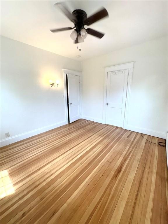 unfurnished bedroom with light wood-style flooring, baseboards, and ceiling fan
