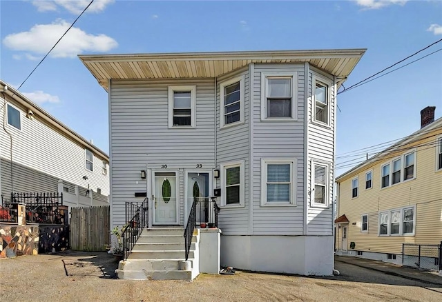 view of front of property featuring fence
