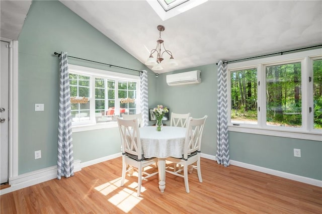 745 Eagle Peak Rd, Burrillville, RI 02859 - dining room with a wall mounted air conditioner, a skylight, light wood-style floors, vaulted ceiling, and baseboards