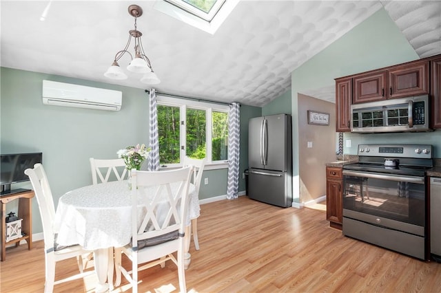 745 Eagle Peak Rd, Burrillville, RI 02859 - kitchen with stainless steel appliances, a wall mounted air conditioner, lofted ceiling, a skylight, and light wood-type flooring