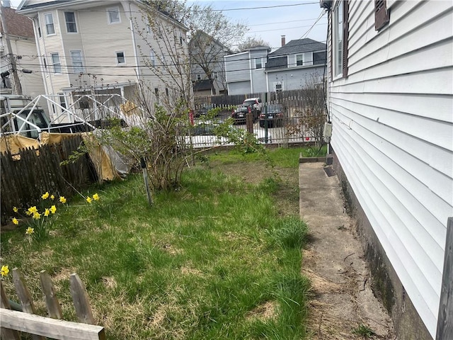 view of yard featuring fence and a residential view