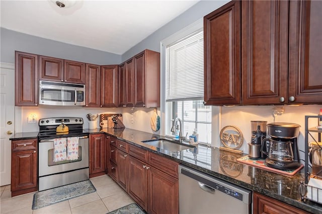 85 Mill St, Newport, RI 02840 - kitchen with stainless steel appliances, a sink, dark stone counters, and light tile patterned flooring