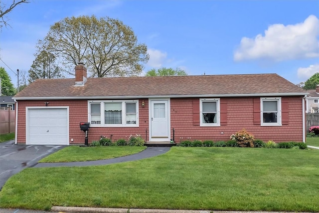 single story home featuring a chimney, a front yard, roof with shingles, and an attached garage