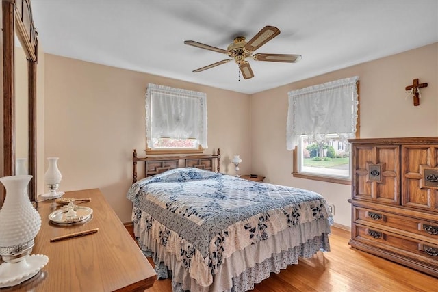 bedroom with light wood finished floors and a ceiling fan