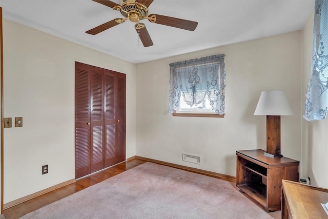 bedroom with a closet, baseboards, multiple windows, and a ceiling fan