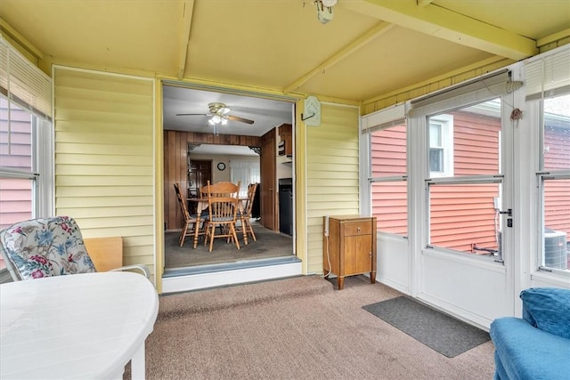 sunroom / solarium with a ceiling fan