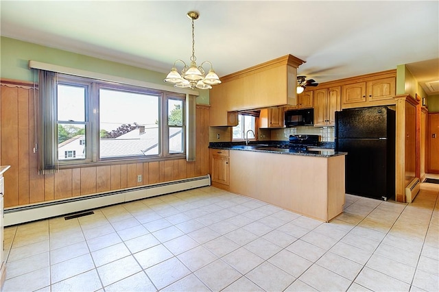 kitchen with a peninsula, a wealth of natural light, black appliances, and baseboard heating