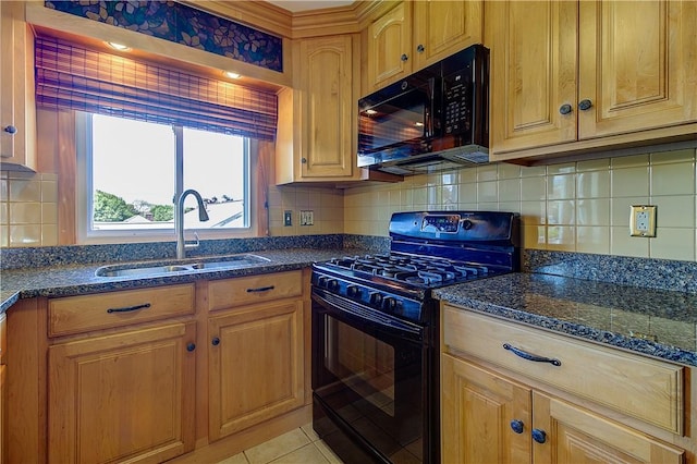 kitchen featuring a sink, dark stone counters, black appliances, backsplash, and light tile patterned floors