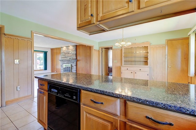 kitchen featuring dark stone counters, dishwasher, pendant lighting, an inviting chandelier, and light tile patterned floors