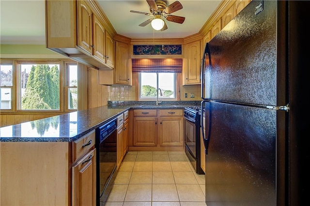 kitchen with light tile patterned floors, black appliances, decorative backsplash, and a sink