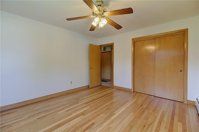 unfurnished bedroom with light wood finished floors, a closet, and baseboards