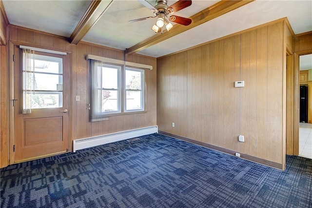 unfurnished room with ceiling fan, wooden walls, carpet flooring, and a baseboard heating unit