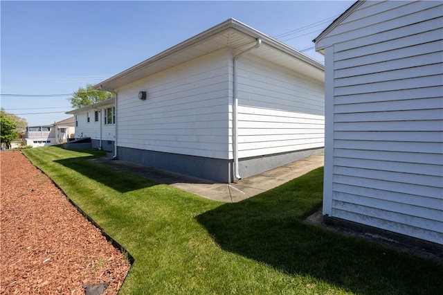 view of side of home with a lawn