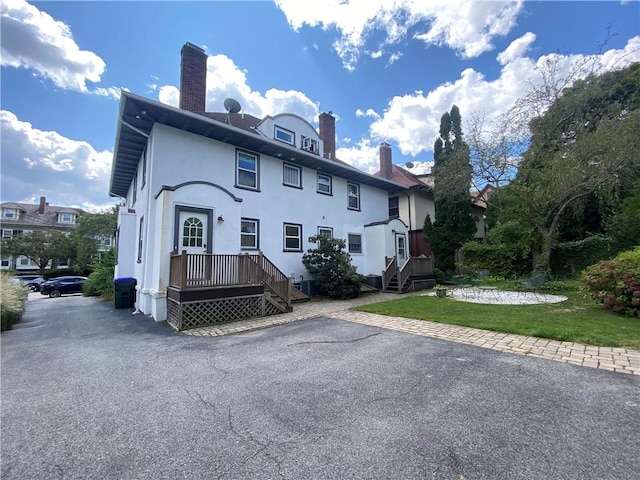 404 Lloyd Ave Unit 408, Providence, RI 02906 - view of front of house featuring a chimney, stucco siding, and a front yard