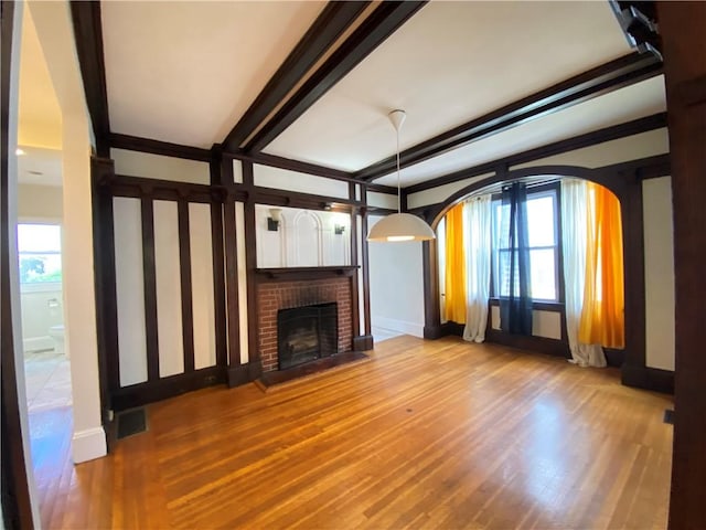 404 Lloyd Ave Unit 408, Providence, RI 02906 - unfurnished living room featuring plenty of natural light, wood finished floors, and a fireplace