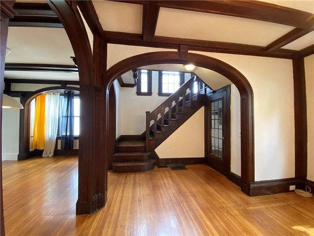 404 Lloyd Ave Unit 408, Providence, RI 02906 - foyer entrance with arched walkways, wood finished floors, stairs, beam ceiling, and baseboards