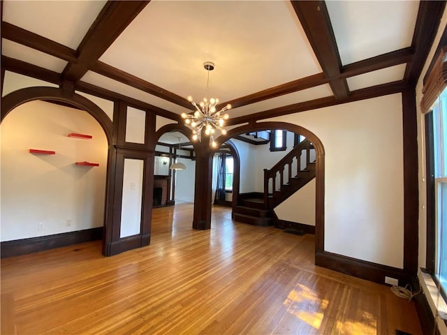 404 Lloyd Ave Unit 408, Providence, RI 02906 - spare room with arched walkways, coffered ceiling, a chandelier, wood finished floors, and beamed ceiling