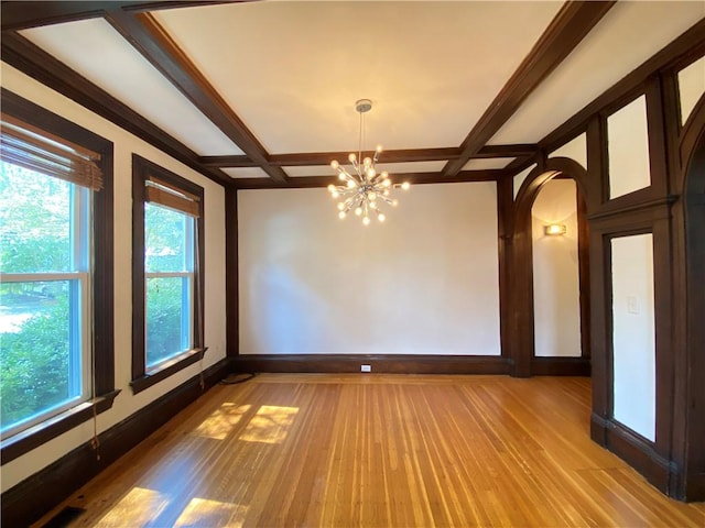 404 Lloyd Ave Unit 408, Providence, RI 02906 - spare room featuring baseboards, coffered ceiling, a chandelier, light wood-style flooring, and arched walkways