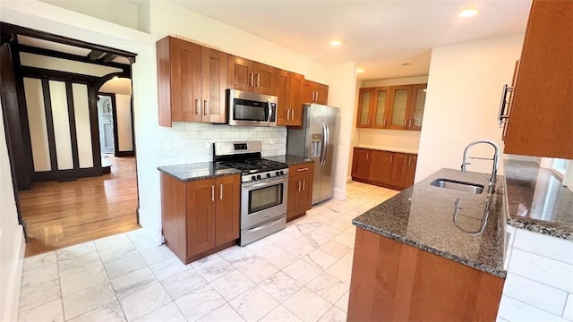404 Lloyd Ave Unit 408, Providence, RI 02906 - kitchen with stainless steel appliances, a sink, brown cabinets, dark stone countertops, and recessed lighting