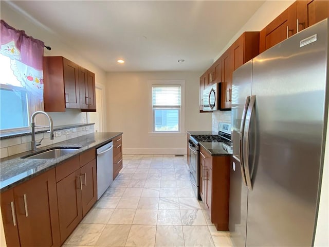 404 Lloyd Ave Unit 408, Providence, RI 02906 - kitchen with appliances with stainless steel finishes, a sink, dark stone counters, recessed lighting, and tasteful backsplash