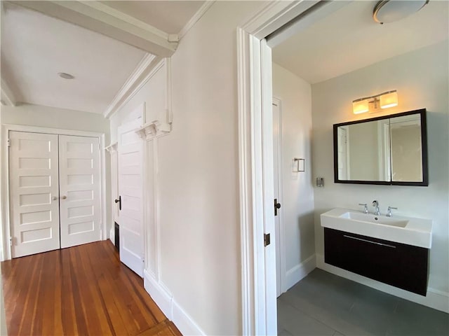 404 Lloyd Ave Unit 408, Providence, RI 02906 - bathroom with baseboards, vanity, wood finished floors, and crown molding