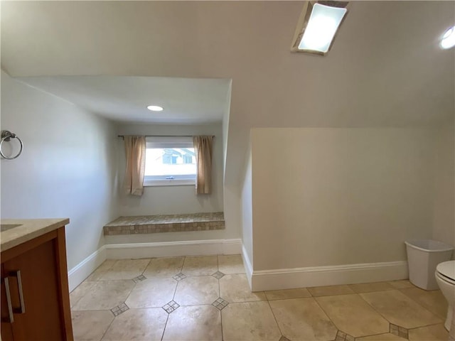 404 Lloyd Ave Unit 408, Providence, RI 02906 - full bathroom featuring toilet, baseboards, tile patterned flooring, and vanity