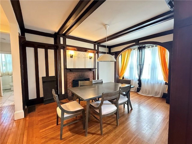 404 Lloyd Ave Unit 408, Providence, RI 02906 - dining space with hardwood / wood-style floors, a brick fireplace, and beam ceiling
