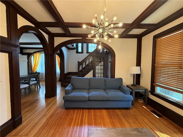 404 Lloyd Ave Unit 408, Providence, RI 02906 - living room featuring arched walkways, coffered ceiling, a chandelier, healthy amount of natural light, and beam ceiling