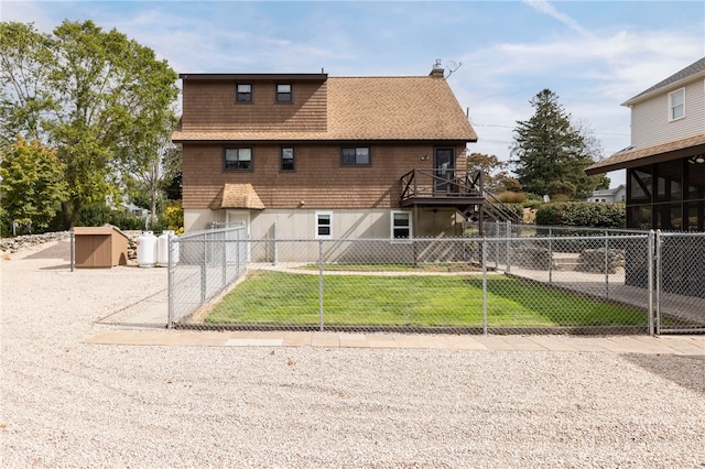 82 Uzzi Ave, Westerly, RI 02891 - back of property with a storage shed, a chimney, a lawn, a fenced front yard, and an outbuilding
