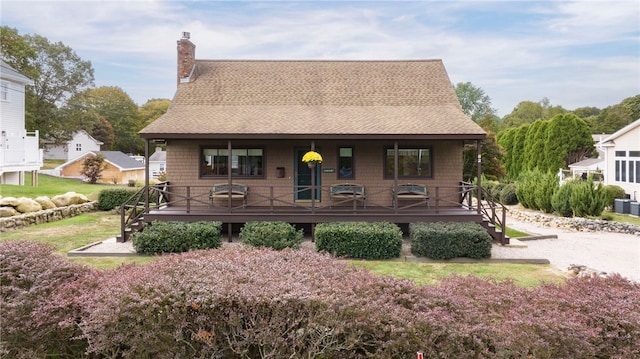 82 Uzzi Ave, Westerly, RI 02891 - view of front of home featuring covered porch, roof with shingles, and a chimney