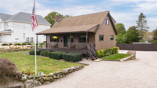 82 Uzzi Ave, Westerly, RI 02891 - view of front of house with a porch, roof with shingles, a chimney, and a front yard