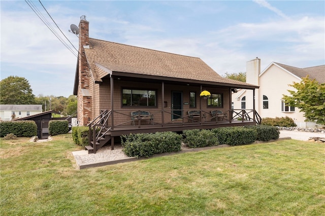 82 Uzzi Ave, Westerly, RI 02891 - back of property featuring a shingled roof, a yard, and a chimney
