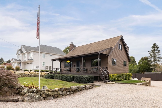 82 Uzzi Ave, Westerly, RI 02891 - view of front of property with a chimney, fence, a shingled roof, a front yard, and a porch