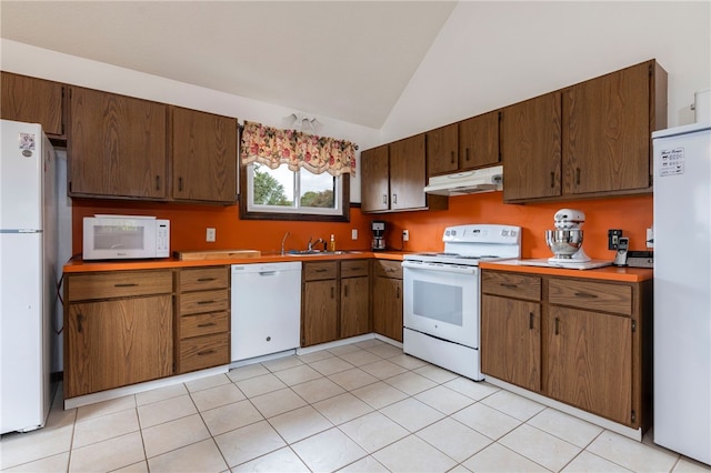 82 Uzzi Ave, Westerly, RI 02891 - kitchen with a sink, white appliances, under cabinet range hood, light countertops, and vaulted ceiling