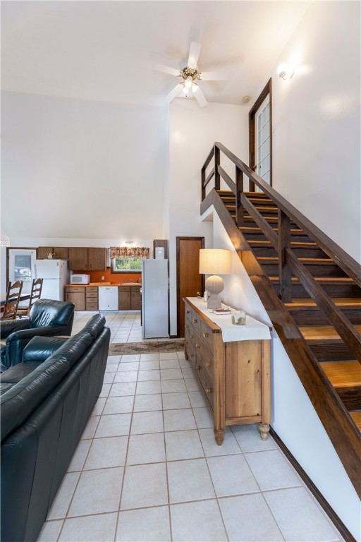 82 Uzzi Ave, Westerly, RI 02891 - living area featuring a ceiling fan, stairs, light tile patterned flooring, and high vaulted ceiling