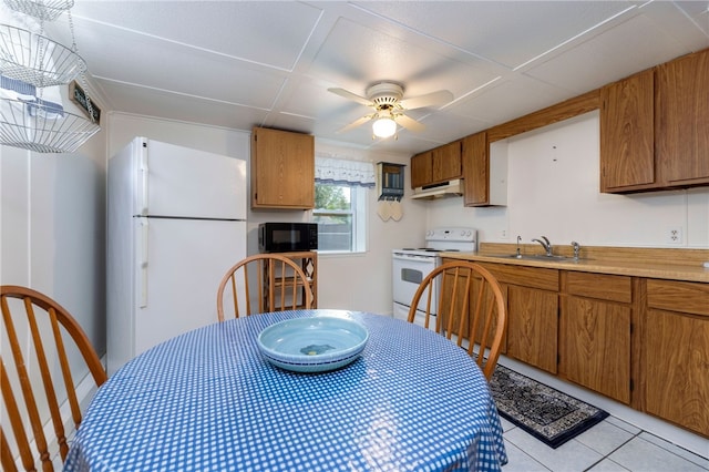 82 Uzzi Ave, Westerly, RI 02891 - kitchen featuring under cabinet range hood, brown cabinets, and white appliances