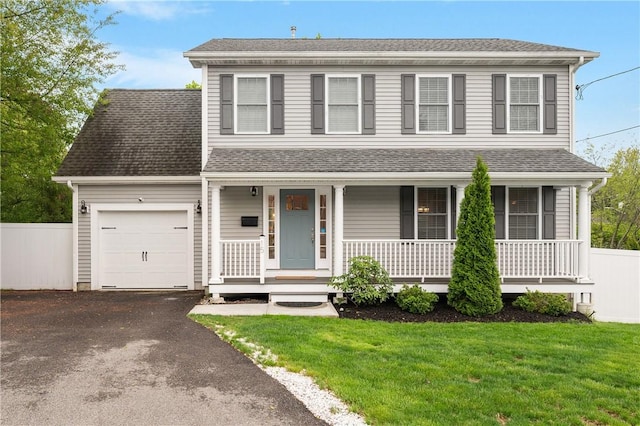 view of front facade featuring a garage, asphalt driveway, a porch, and roof with shingles