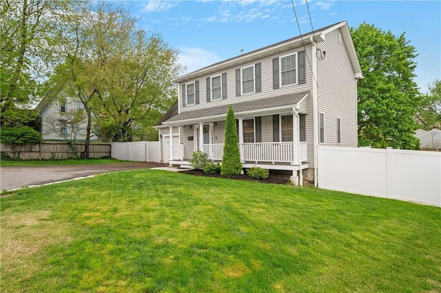 colonial inspired home with covered porch and asphalt driveway