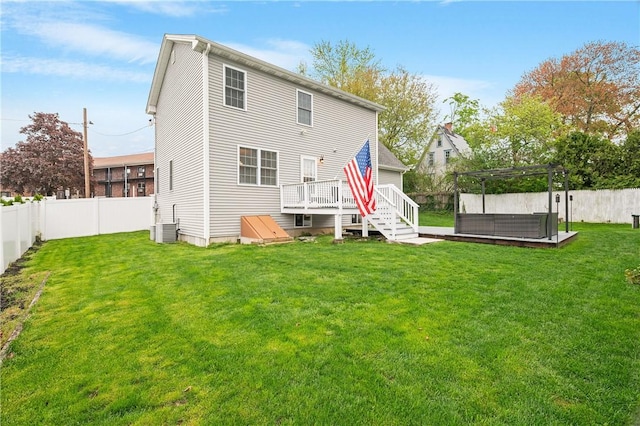 back of property with a wooden deck, a jacuzzi, a pergola, and cooling unit