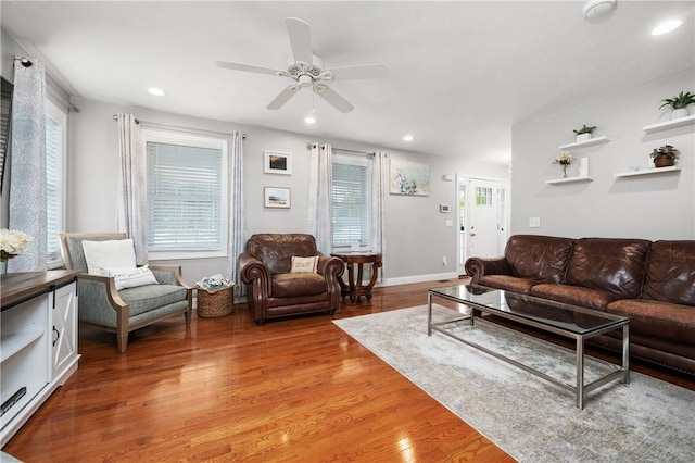 living area featuring light wood-style flooring, ceiling fan, recessed lighting, and baseboards