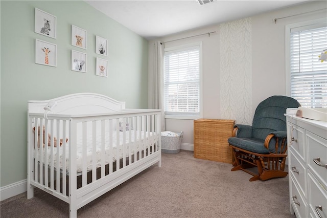 bedroom with carpet flooring and a nursery area